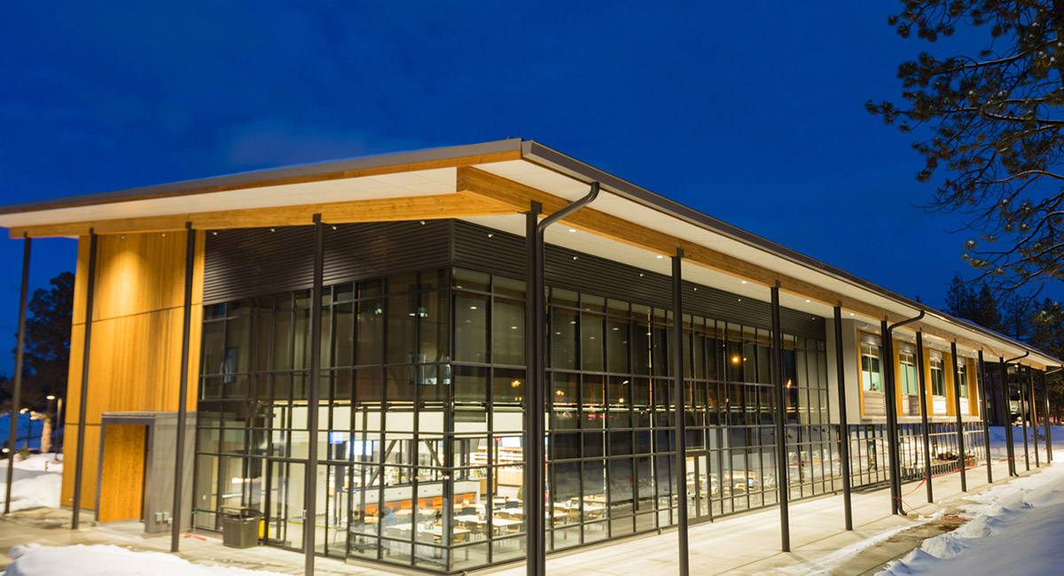 A building lit up at night on the Oregon State-Cascades campus in Bend.